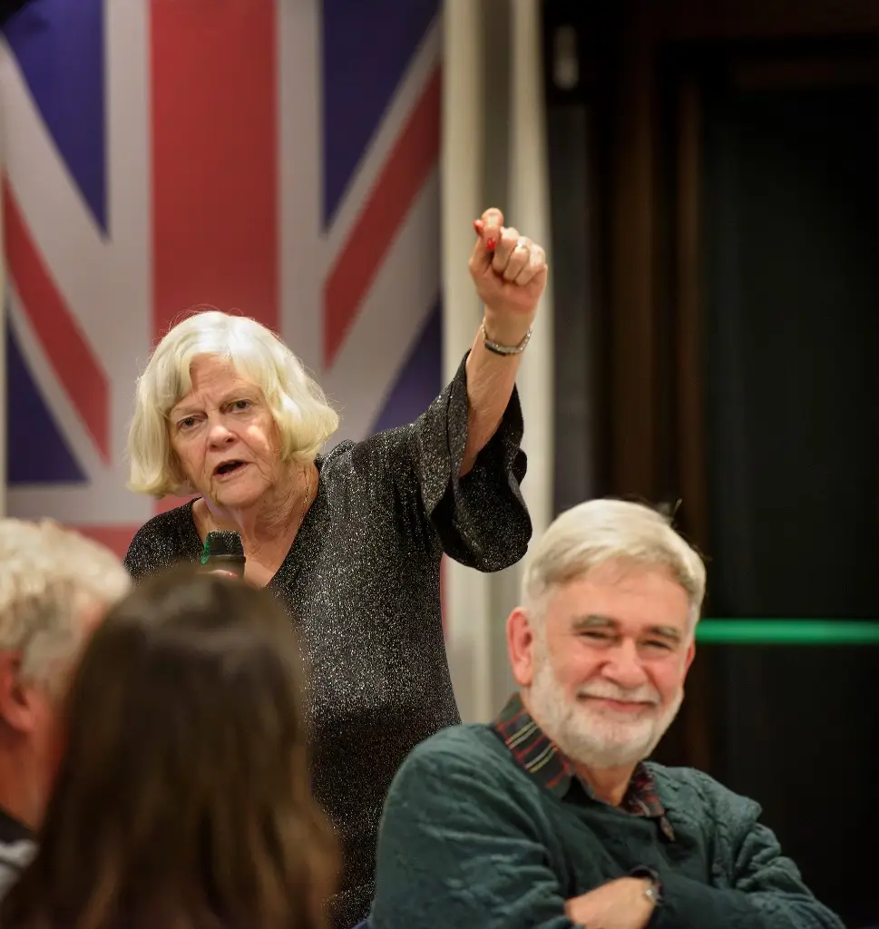 Ann makes her speech while Tim listens